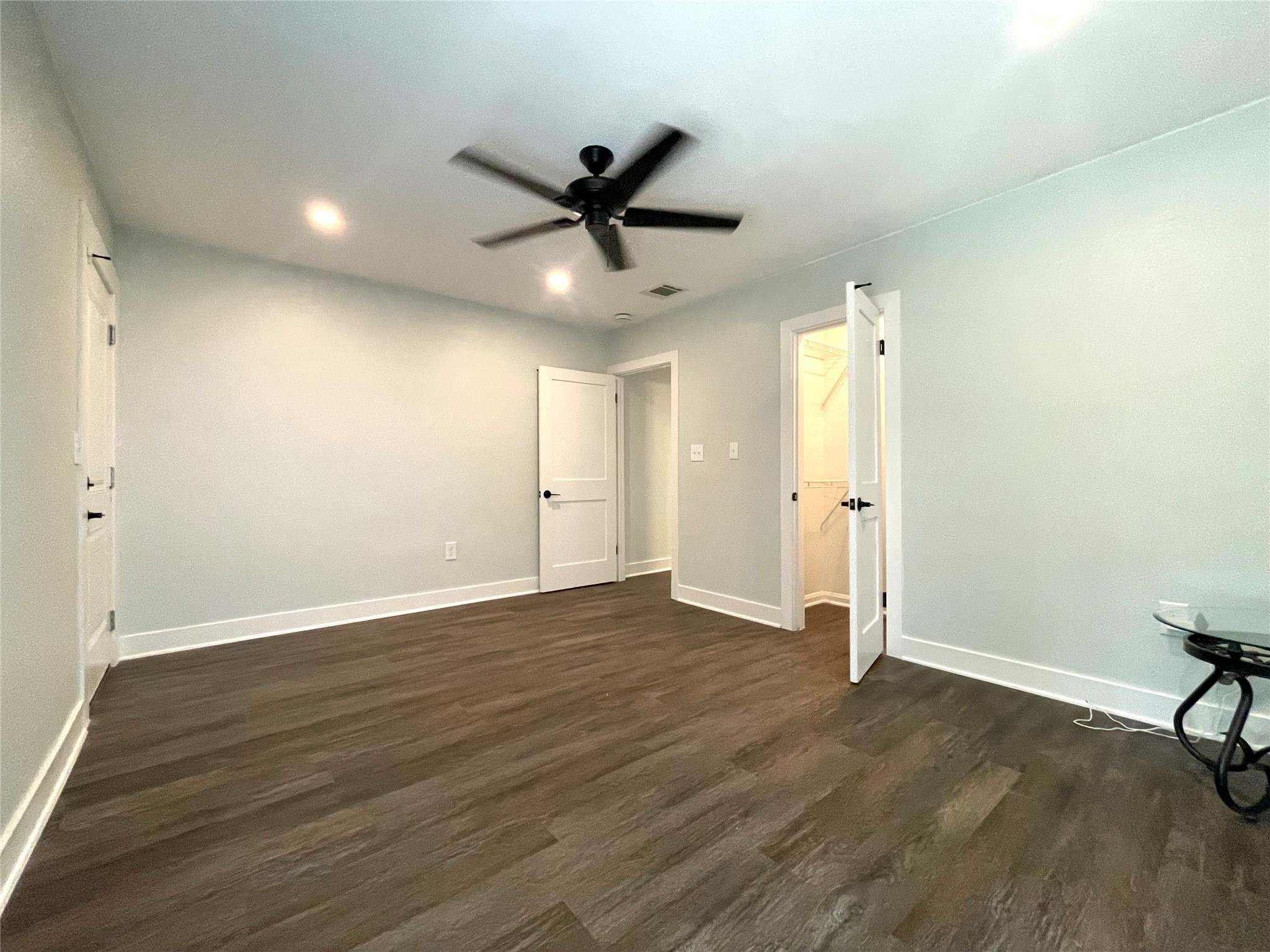 807 East Riverside Drive, Unit B Austin, TX 78704 - Photo 23 of 28 A comfortable bedroom with rich wood like flooring and a refreshing ceiling fan for optimal comfort.