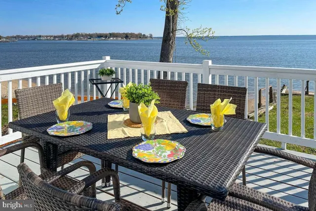 a view of a balcony with wooden floor and outdoor seating