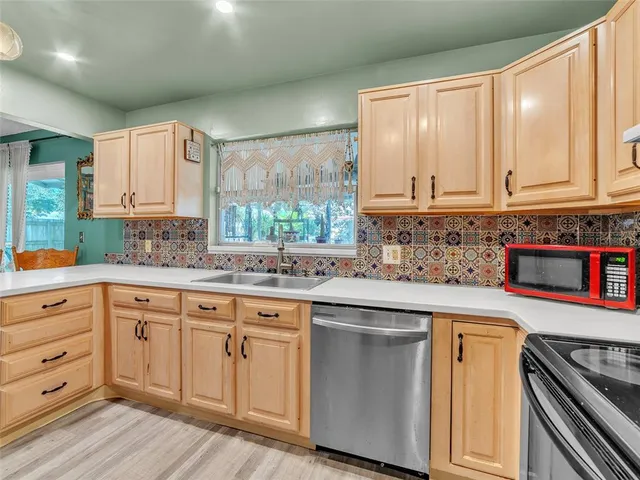 a kitchen with granite countertop white cabinets and white appliances