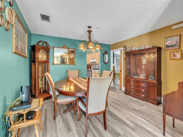 a view of a dining room with furniture and chandelier