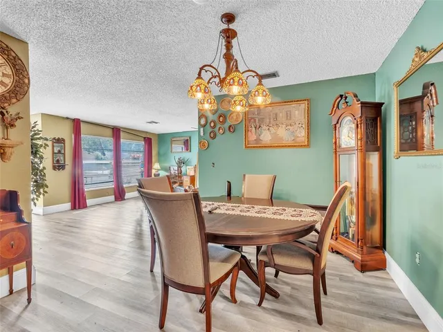 a view of a dining room with furniture wooden floor and chandelier