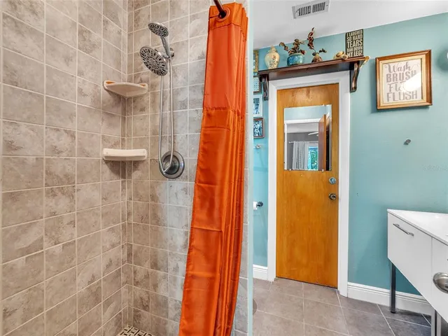 a bathroom with a shower and a sink