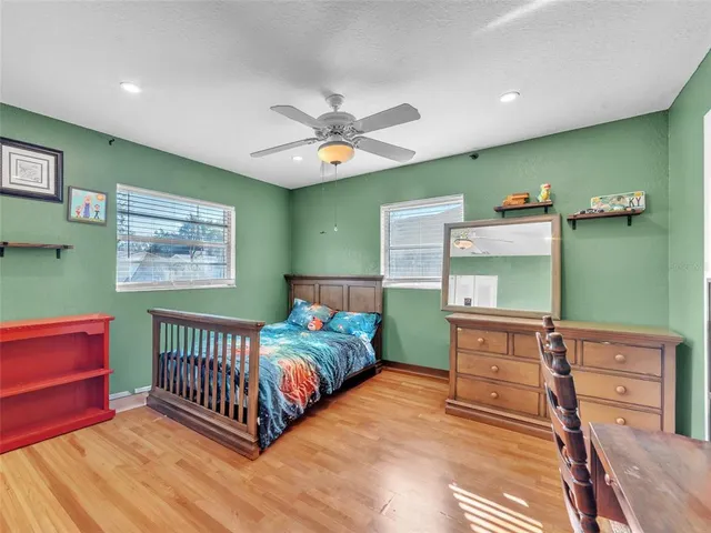 a bedroom with a bed and a dresser in it