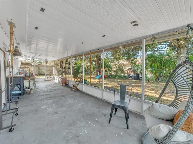 a room with patio furniture and a large window