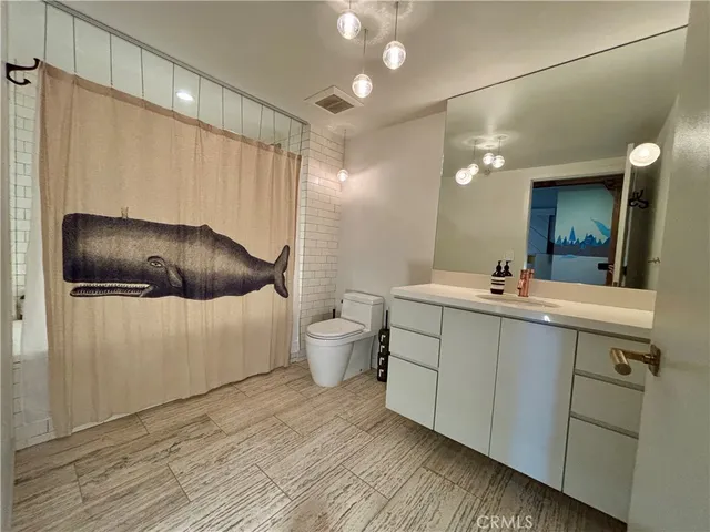 a bathroom with a double vanity sink mirror and toilet