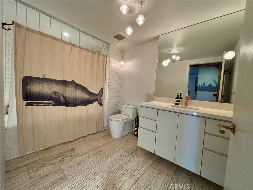 527 Molino Street, Unit 401 Los Angeles, CA 90013 - Photo 19 of 31 a bathroom with a double vanity sink mirror and toilet