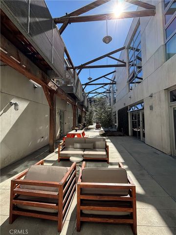 a view of a patio with a table and chairs under an umbrella