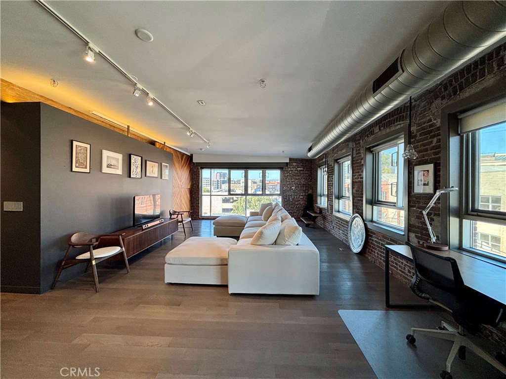 527 Molino Street, Unit 401 Los Angeles, CA 90013 - Photo 7 of 31 a living room with furniture and a large window