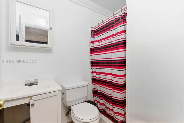 a bathroom with a white toilet and a sink