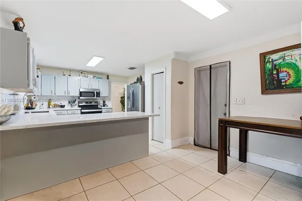 a kitchen with stainless steel appliances a refrigerator and a stove top oven