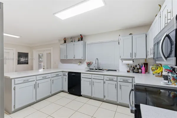 a kitchen with a sink cabinets and window
