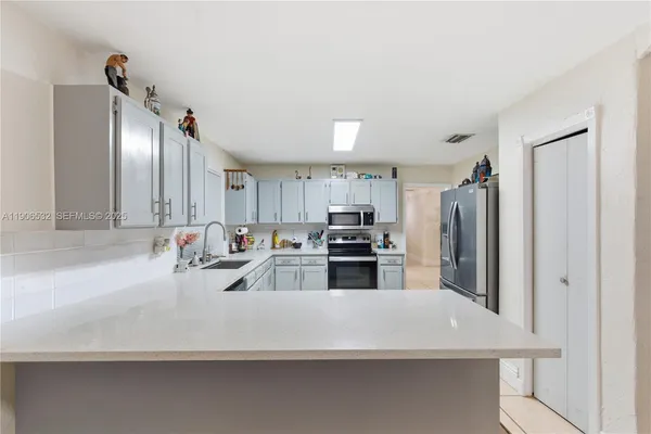 a kitchen with stainless steel appliances a refrigerator and a sink