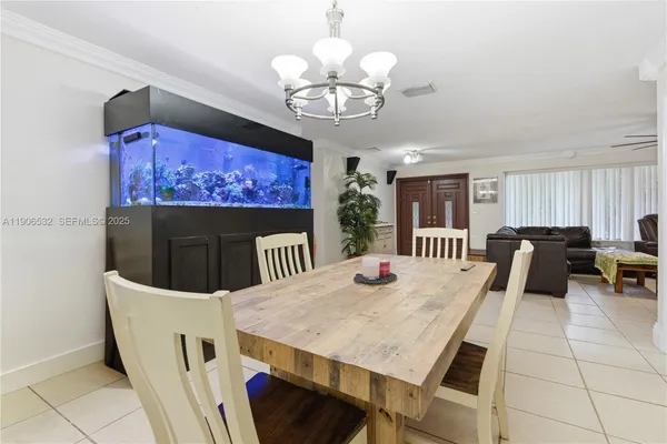 a view of a dining room with furniture and chandelier