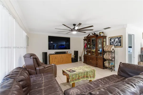a living room with furniture ceiling fan and a rug