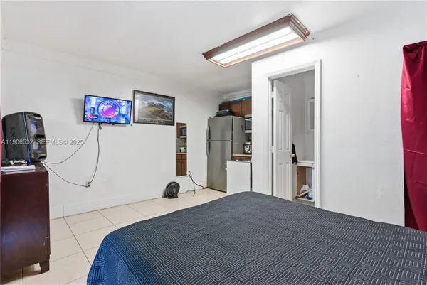a bedroom with a bed and a flat screen tv