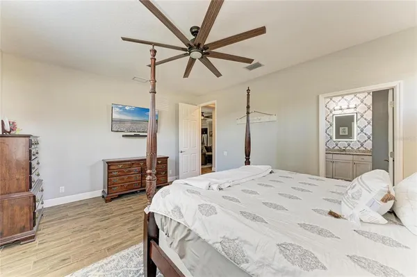 a bedroom with a bed and a chandelier