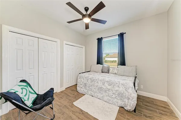 a living room with patio furniture and a floor to ceiling window