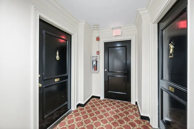 a view of a dining room with furniture a chandelier and wooden floor