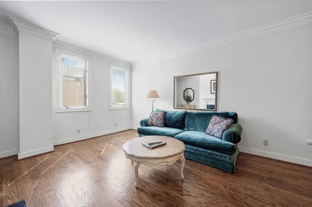 a kitchen with stainless steel appliances a sink dishwasher a stove top oven a refrigerator with wooden cabinets and floor