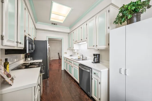 a spacious bedroom with a bed and a cabinets