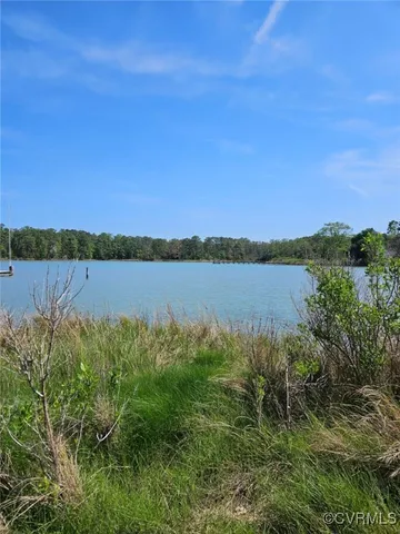 a view of a lake with houses in the back