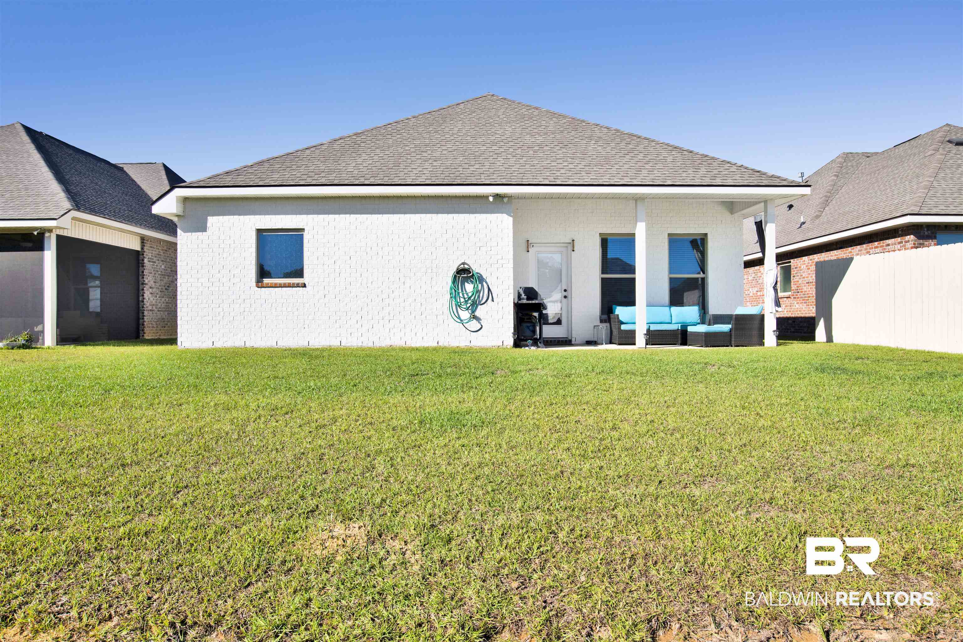 1406 Aldon Street Foley, AL 36535 - Photo 29 of 30 Rear view of house with outdoor lounge area and a lawn