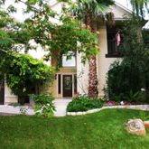 a view of a chair and table in the garden
