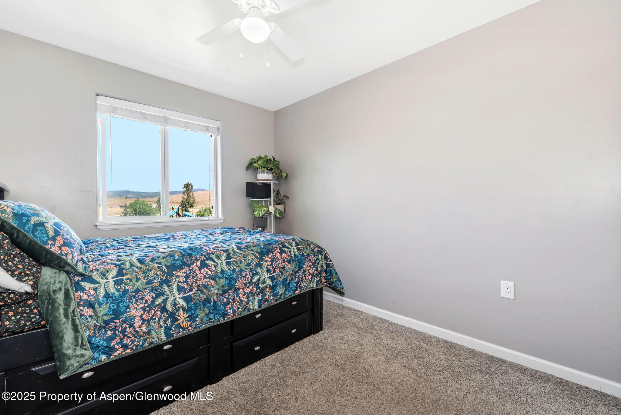 875 Dry Creek Road Hayden, CO 81639 - Photo 26 of 40 a bedroom with a bed and a window