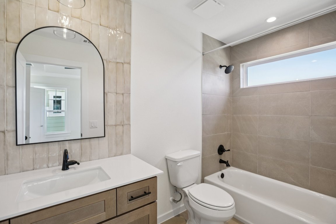 2414 Drew Lane, Unit 5 Austin, TX 78748 - Photo 19 of 33 a bathroom with a sink a toilet and a mirror