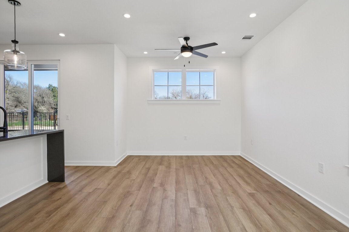 2414 Drew Lane, Unit 5 Austin, TX 78748 - Photo 7 of 33 a view of wooden floor and a chandelier in a room