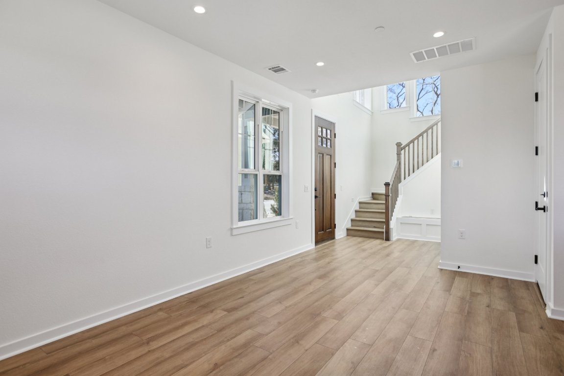 2414 Drew Lane, Unit 5 Austin, TX 78748 - Photo 10 of 33 a view of an empty room with wooden floor and a window