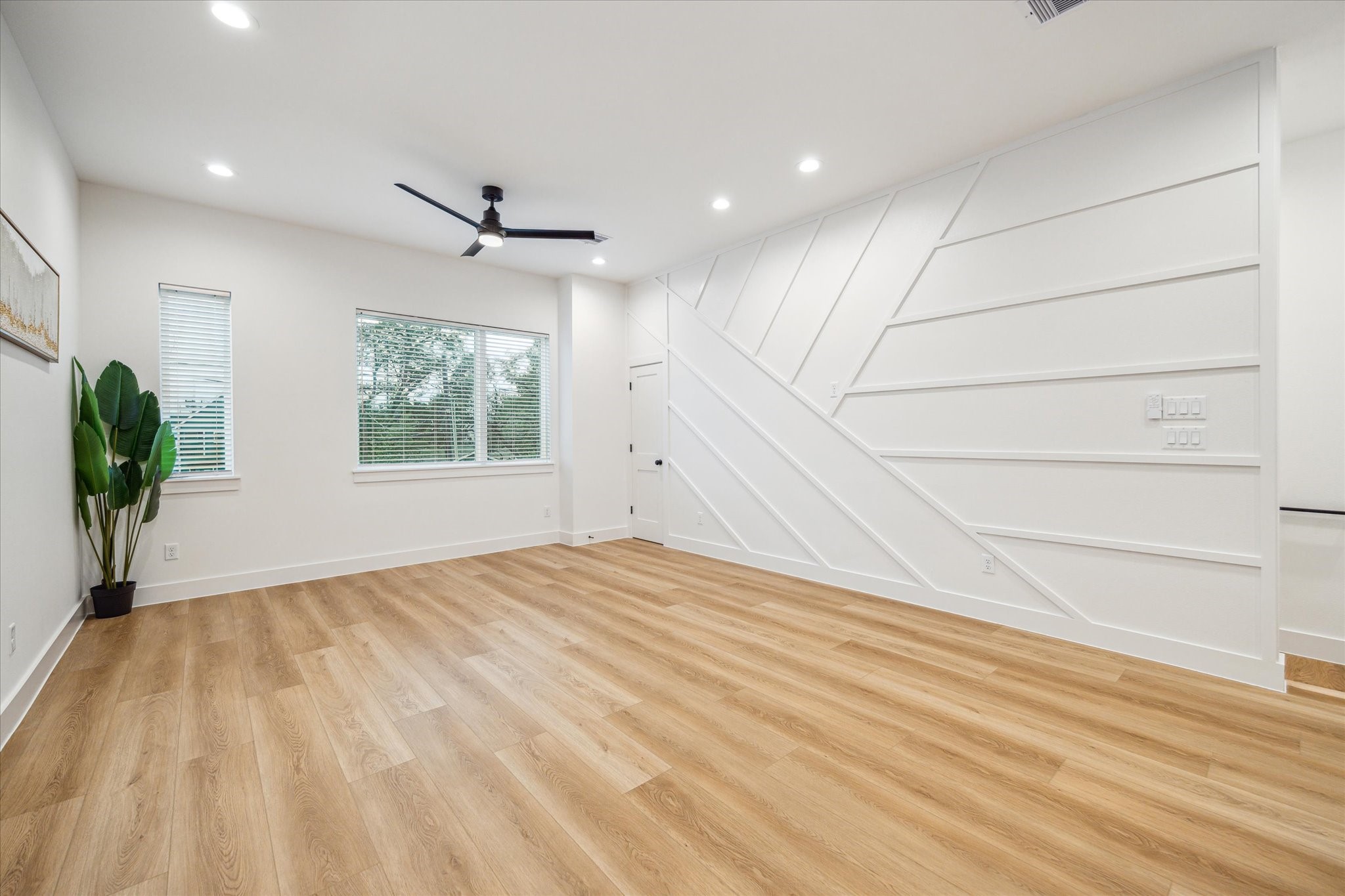 3506 Delhi Street, Unit A Houston, TX 77022 - Photo 4 of 15 an empty room with windows and ceiling fan