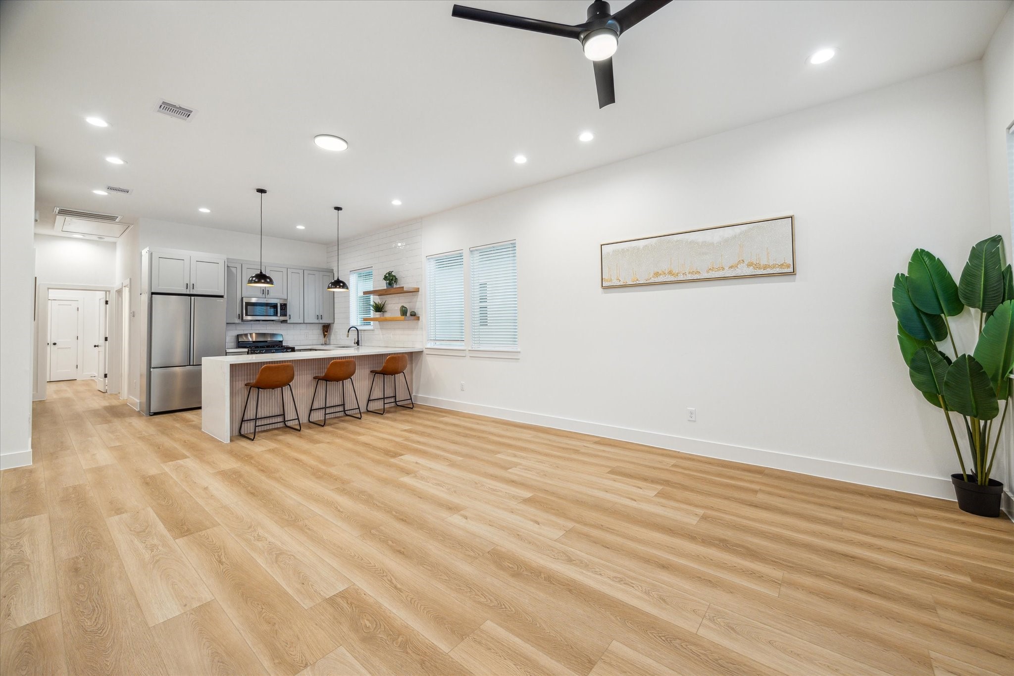 3506 Delhi Street, Unit A Houston, TX 77022 - Photo 6 of 15 a living room with stainless steel appliances kitchen island granite countertop furniture and a wooden floor