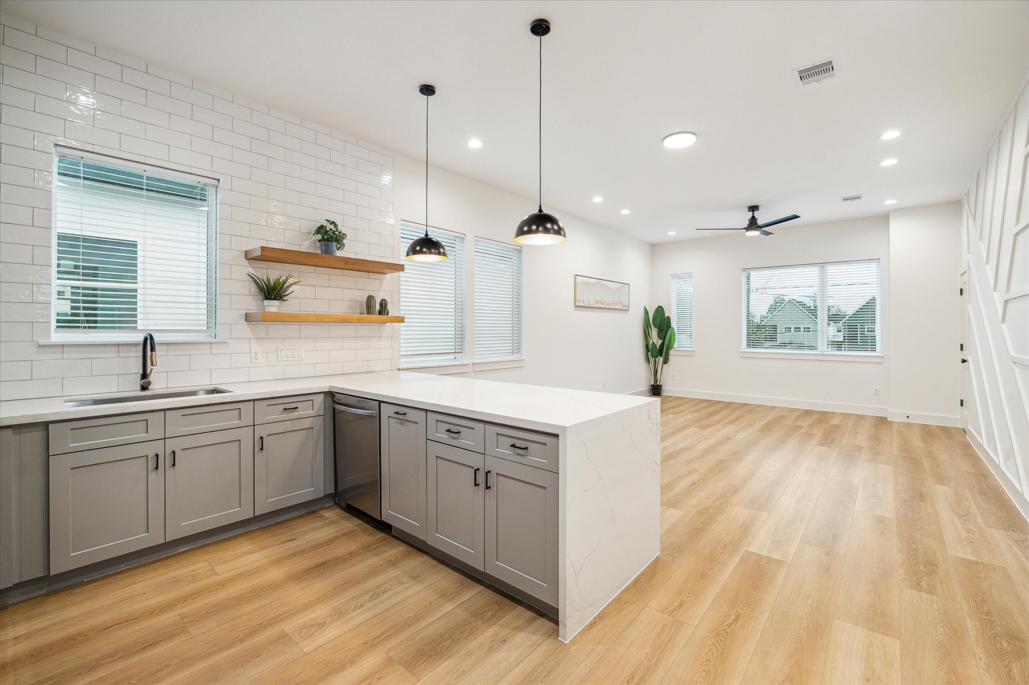 3506 Delhi Street, Unit A Houston, TX 77022 - Photo 9 of 15 a large kitchen with stainless steel appliances granite countertop a stove a sink and a wooden floors