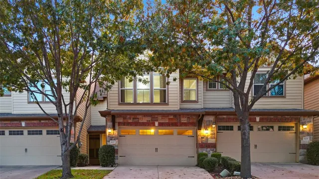 a view of a house with large tree