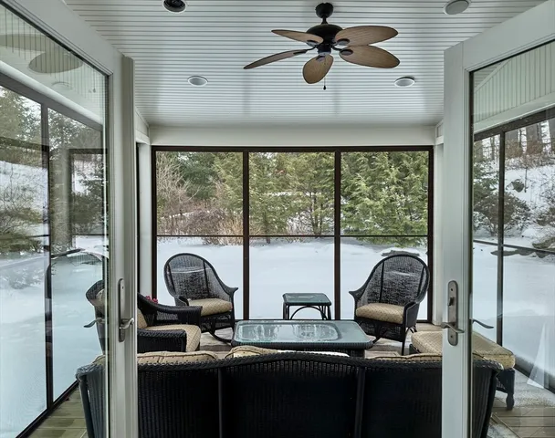 a living room with furniture and a floor to ceiling window