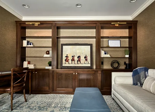 a view of a hallway with workspace and wooden floor