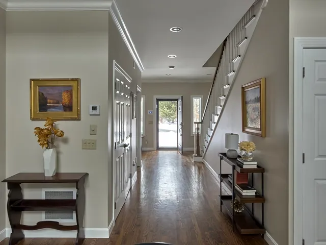 a view of hallway with furniture and wooden floor