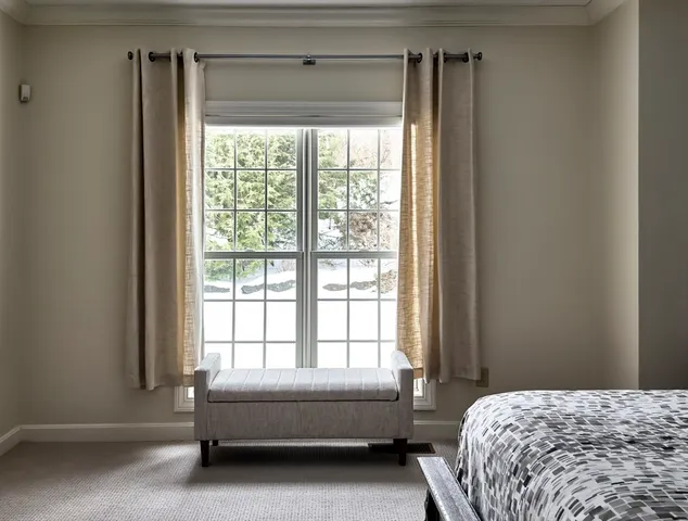 a bedroom with a large bed and a window