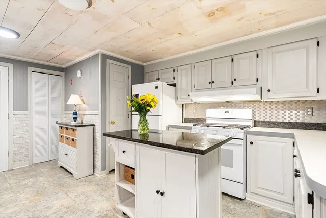 a kitchen with a sink stove and cabinets