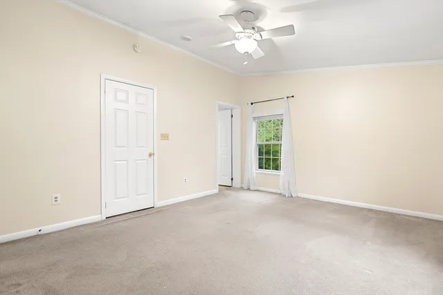 an empty room with a empty space and a ceiling fan