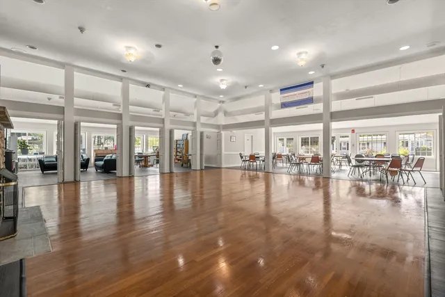 a dining room with furniture window and wooden floor
