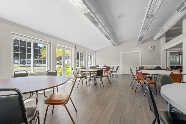 a view of a living room kitchen with furniture and wooden floor