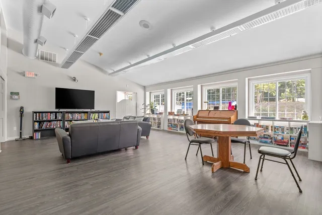 a view of a swimming pool with lawn chairs and a big yard