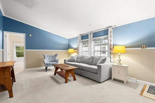 a living room with furniture and a lamp