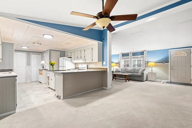 a kitchen with stainless steel appliances granite countertop a sink a stove and cabinets