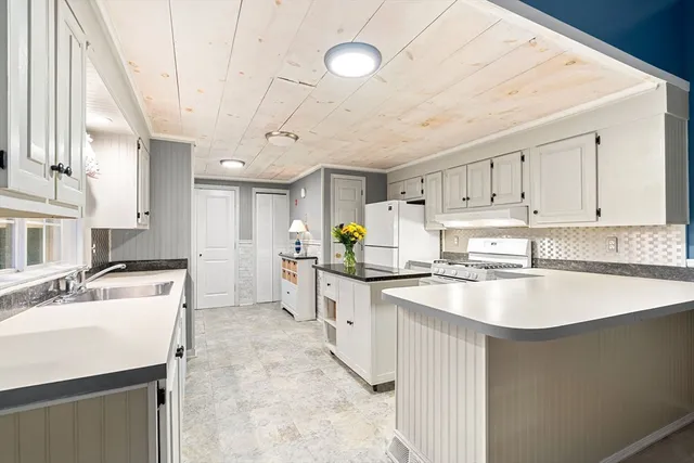an open kitchen with a sink and a cabinet