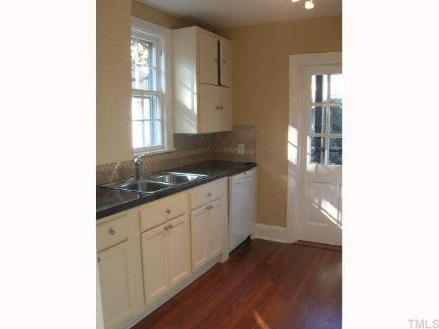 127 Brooks Avenue Raleigh, NC 27607 - Photo 6 of 11 Remodeled kitchen w/new flooring, cabinets, solid surface counter-tops, new stainless sink, tile detailing and appliances including range, dishwasher, refrigerator.