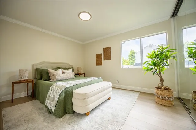 a bedroom with a bed and a potted plant