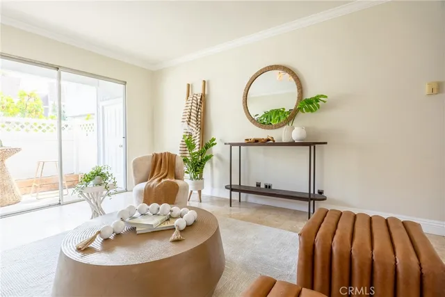 a living room with a table and a potted plant